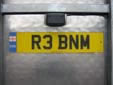 Personalized plate (rear) with an unofficial,<br>but permitted, ENG band. ENG = England<br>R = registered between August 1997 and July 1998<br>NM = Luton, but this coding does not apply to personalized plates
