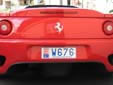 Dealer plate (rear). W = dealer